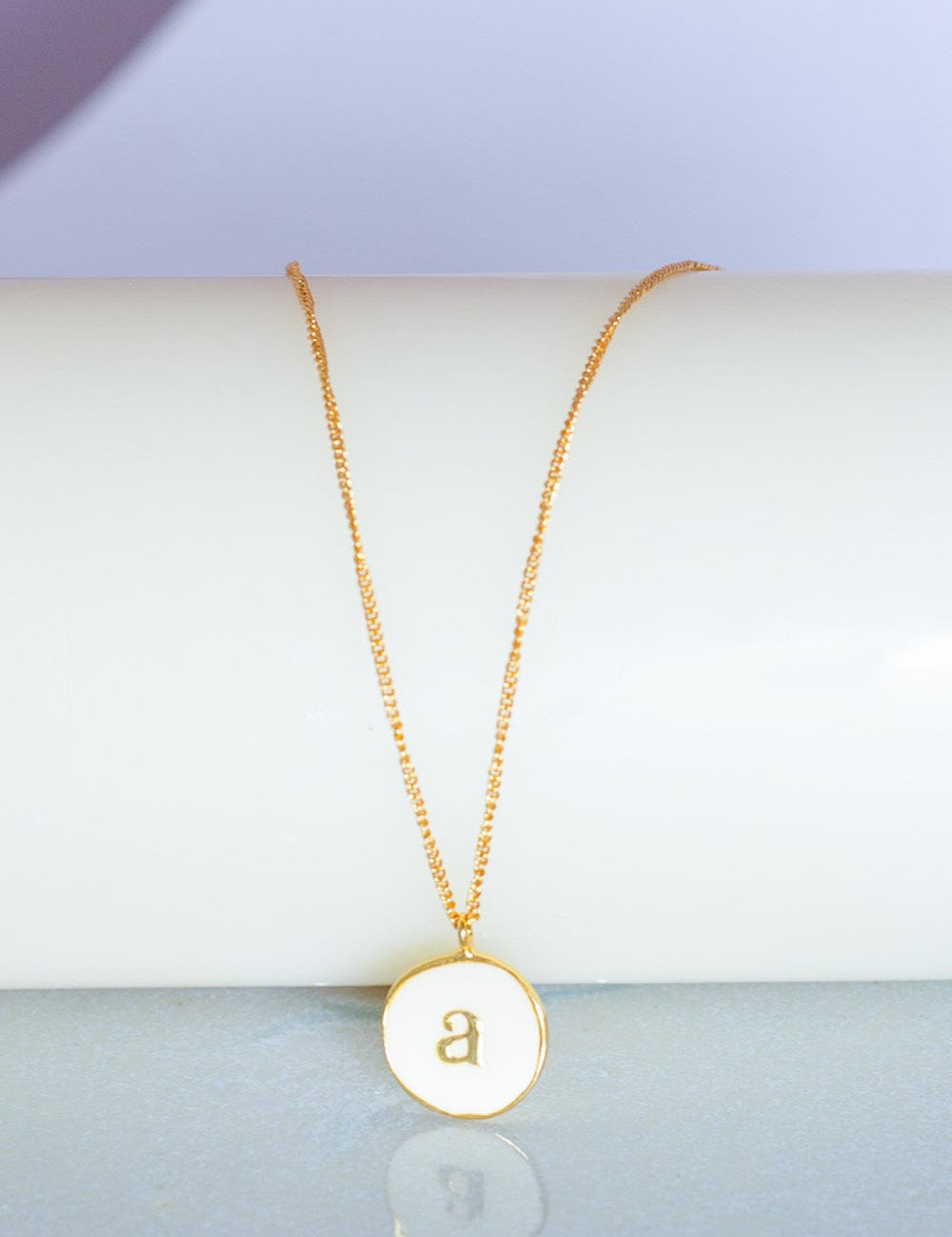 Photoframes & jewellery boxes A Monogram Pendant with Necklace