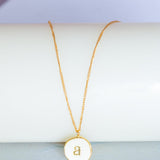 Photoframes & jewellery boxes A Monogram Pendant with Necklace