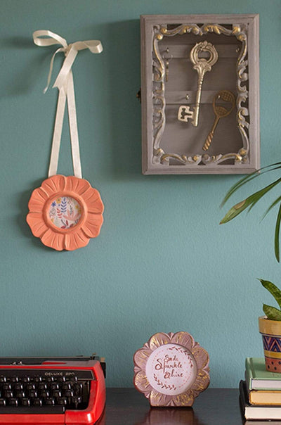 Triad Hanging Photoframe - FlowerMaterial: MANGO WOOD / MDF &amp; GLASS
Dimensions: Dia 14 cms

Do not wash, Use a slightly damp cloth to clean. Wipe dry. Avoid dragging sharp or rough objects acrosTriad Hanging Photoframe - FlowerThe Wishing Chair
